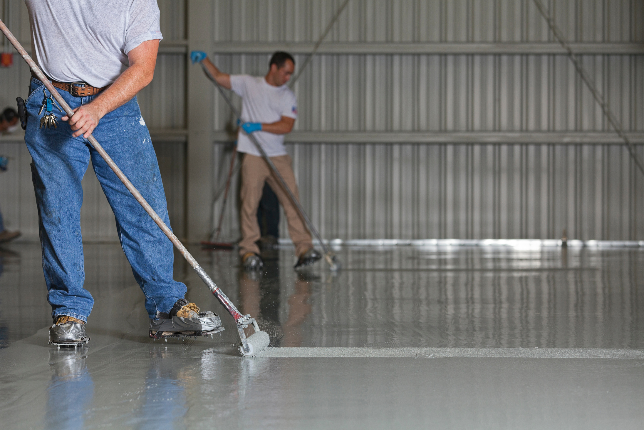 Painters Apply Epoxy Paint to an Airport Hanger